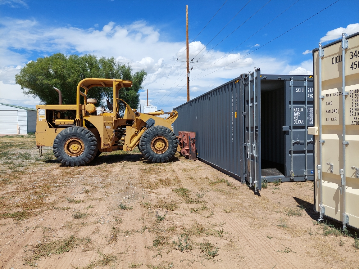 Container being set up and leveled at a customer's property in the Uintah Basin